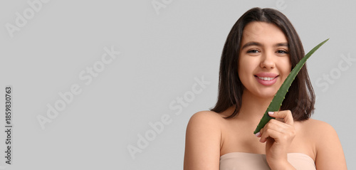 Happy young woman with aloe...