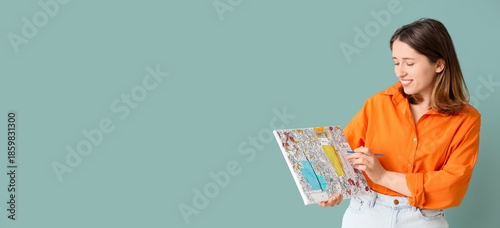 Young woman with painting b...