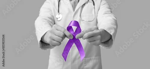 Doctor holding purple aware...