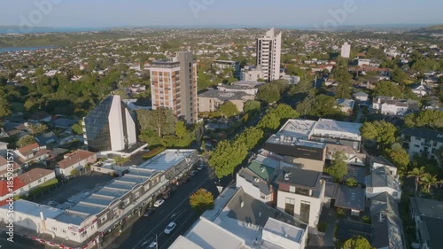 Aerial view of the suburb of Remuera in Auckland, New Zealand, showcasing a mix of residential houses and commercial buildings. The scene highlights the urban landscape and architecture.