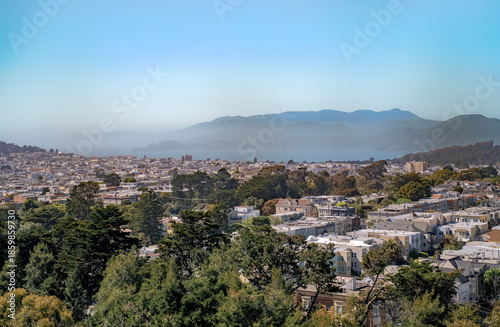 Fog rolls in on a sunny day in San Francisco. The fog comes to the city on a sunny day. San Francisco, California, United States of America