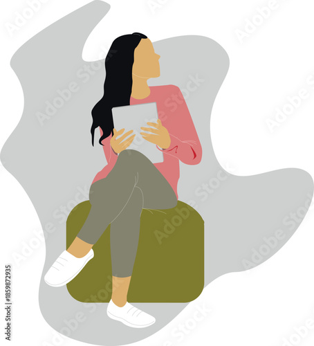 The girl is sitting on an ottoman with a tablet