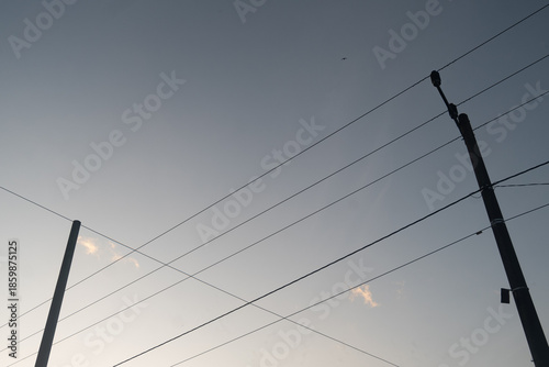 Tableau sur toile Power electric pole with line wire on colored background close up, photography c