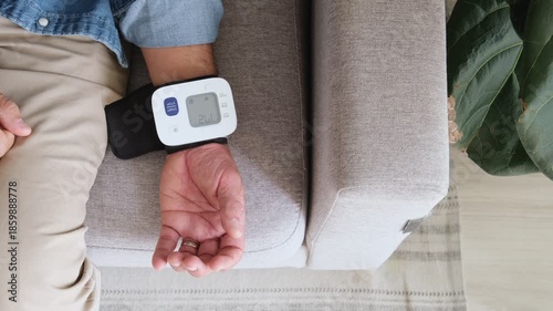 Man checking blood pressure and pulse monitor