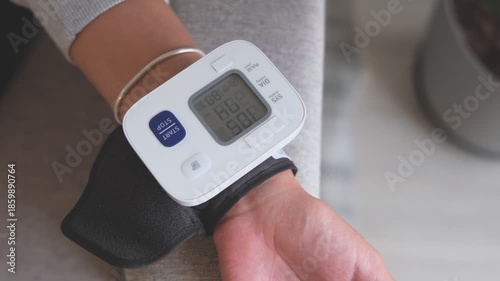 Person monitoring blood pressure using a digital wrist cuff for wellness