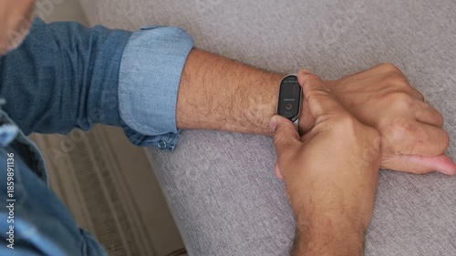 Man using a smart watch to check his pulse and blood pressure for cardiovascular health monitoring