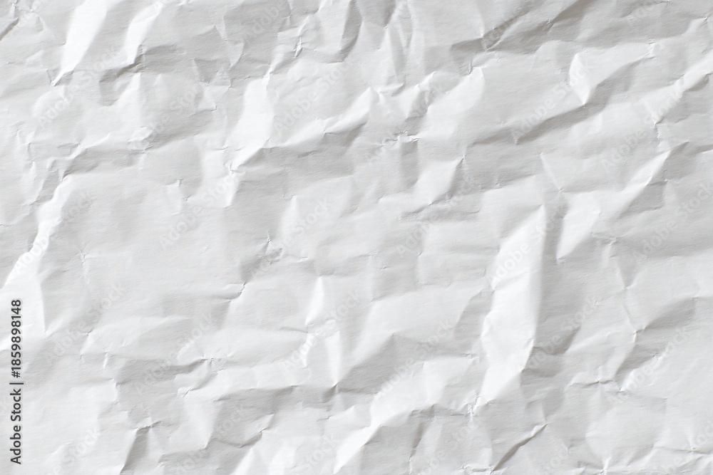 Obraz premium A wrinkled sheet of crumpled white paper, creating an interesting texture and pattern in the light.