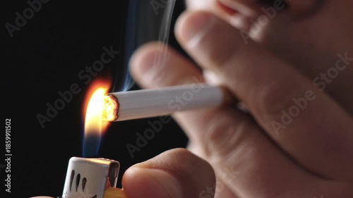 Lighting up smoking cigarettes,Closeup of young man smoking a cigarette