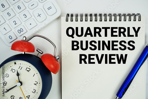 Bild auf Leinwand Quarterly Business Review (QBR) text written on notepad with alarm clock and cal