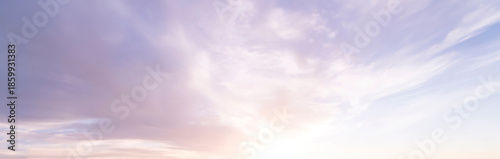 Obraz na płótnie Soft pastel sunrise with feathery white and lavender clouds fanning across a pal