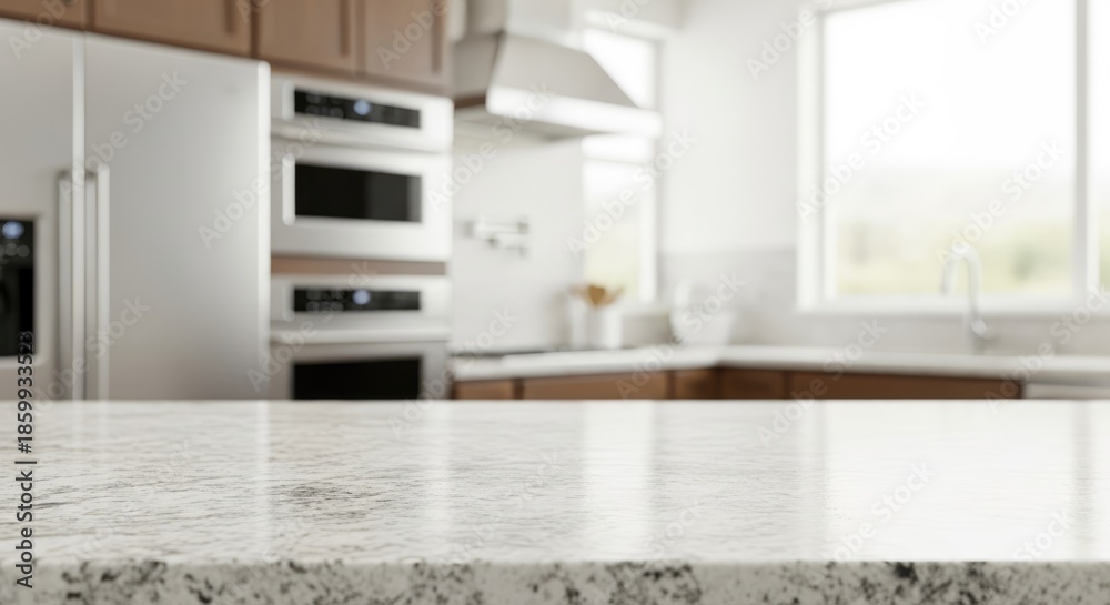 Fototapeta premium A modern kitchen with a white countertop and stainless steel appliances.