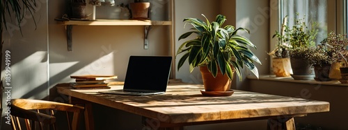A warmly lit workspace features a laptop on a wooden desk, complemented by a potted plant and shelves filled with greenery, creating a cozy and productive atmosphere.