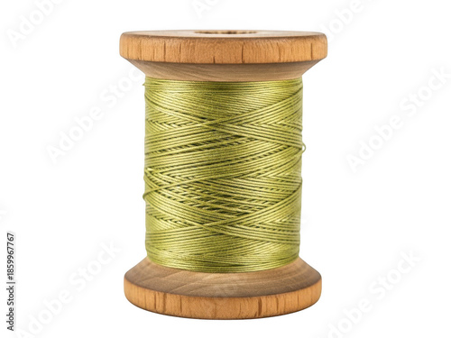 Wooden spool of green thread on black background