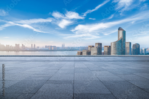 Quadro su tela Empty square floor and modern city buildings with river under blue sky in Hangzh