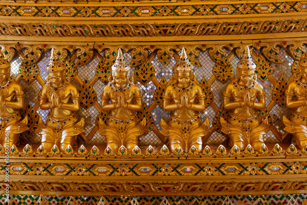 Fototapeta premium Praying statues part of the Interior design, replica of the Sanphet Prasat Palace, at Muang Boran, in Samut Prakan, Thailand. 