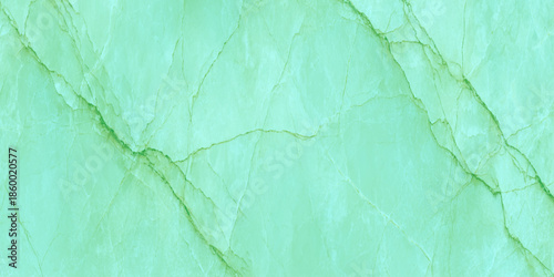 A close up view of a vibrant green stone surface showcasing natural veining and a textured polished appearance