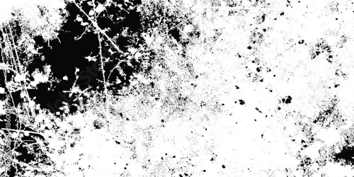 Abstract monochrome texture featuring a chaotic arrangement of dark and light smudges and scratches across the frame