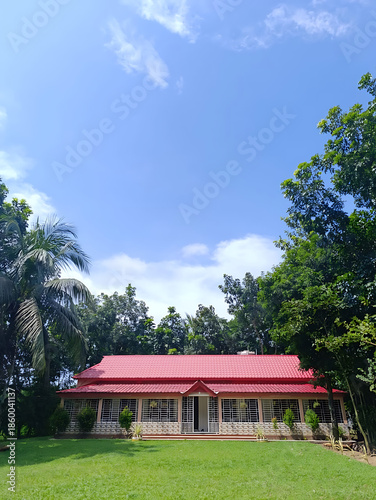 Serene Red-Roofed Cottage Nestled in a Lush Countryside Landscape