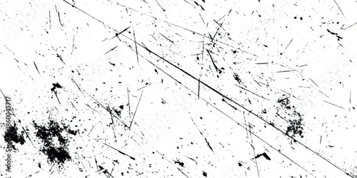 An abstract grunge texture featuring scattered dark smudges fine scratches and angled linear marks across a white background