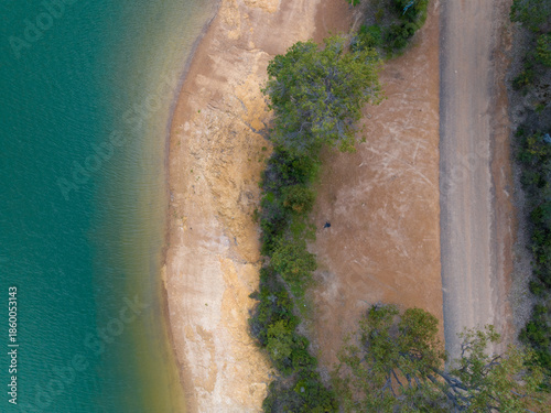 Obraz na plátně Top-down view of vehicle parked beside lakeside shore