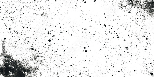 A abstract visual grunge texture of dark spots and smudges scattered across a predominantly white background