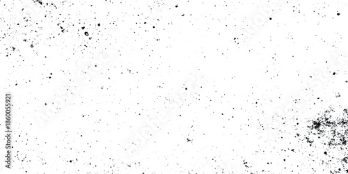 A heavily textured abstract background featuring a multitude of dark specks scattered across a predominantly white surface