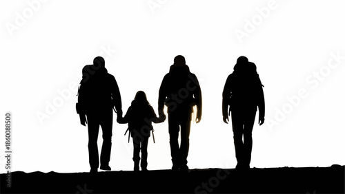 Family hiking adventure silhouette against bright sky.
