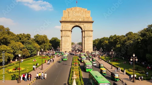 India gate in new delhi with traffic and surrounding park on a sunny day, 4k