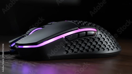 Close Up of Modern Gaming Mouse With Rgb Lighting on Wood Surface