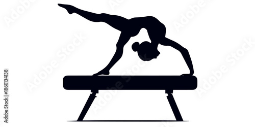 Female gymnast performing balance beam routine in silhouette