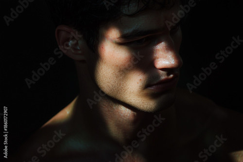 photography portrait of a handsome young man heavily shadowed
