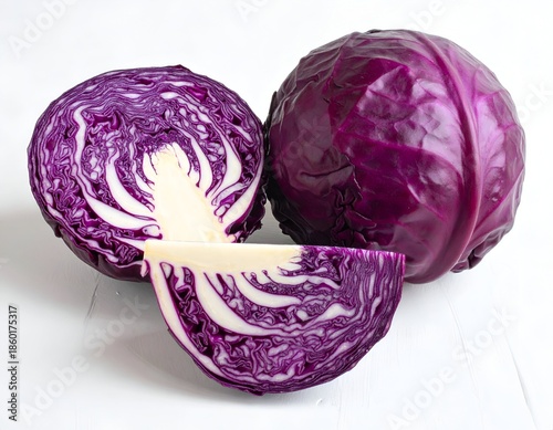 Vibrant purple cabbage, one halved, showing layered leaves, on white