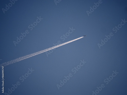 air craft in sky making a fuel mark on the back