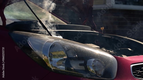 Broken down car with smoke coming out of engine