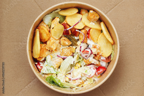 Wallpaper Mural Chicken salad bowl top view. Crispy fries on top layer. Grilled poultry pieces inside. Fresh lettuce and tomatoes mix. Creamy sauce drizzle detail. Takeaway lunch meal concept. Street food style dish. Torontodigital.ca