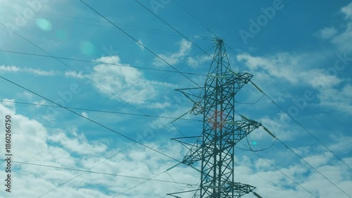 An Electricity Transmission Tower Standing Tall Against a Clear and Bright Blue Sky