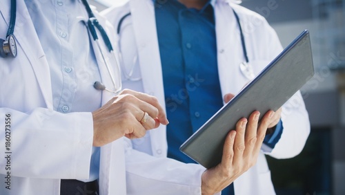 Canvas Print Close view of two doctors standing outside clinic