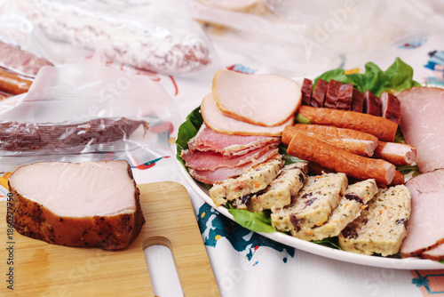 Wallpaper Mural Cold cuts platter on festive table. Sliced ham sausage and meat loaf. Traditional family food for holidays. Party buffet with smoked meats and appetizers. Simple home catering setup. Torontodigital.ca