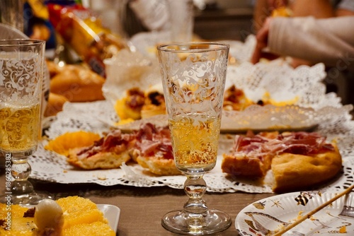 Close-up of a glass of cava or champagne on a blurred holiday catering background.
