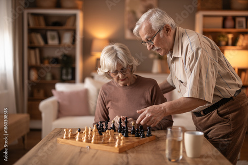 Photography Senior Couple Enjoying Chess Night Together In Cozy Home Living Room Setting