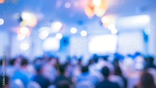 Blurred blue-lit conference audience during a corporate presentation