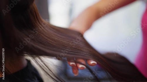 After the procedure, the master checks the condition of the hair for shine and smoothness. High quality 4k footage