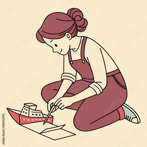Girl crafting a paper boat with a brush