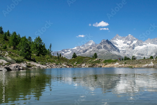 Mountain lake Grünsee with clear water and mountains in the background, Switzerland