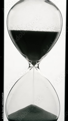 Monochrome of sand in hourglass on white background