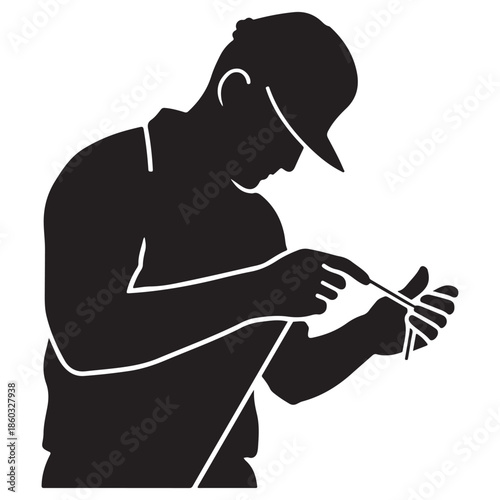  A black silhouette illustration showing a craftsman performing detailed work with a small tool