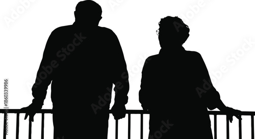 Silhouette of a man and woman standing on a balcony or bridge
