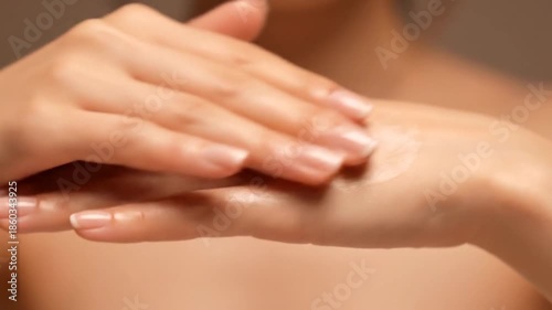 Wallpaper Mural Close-up view of hands applying cream, soft skin, with a blurred background Torontodigital.ca
