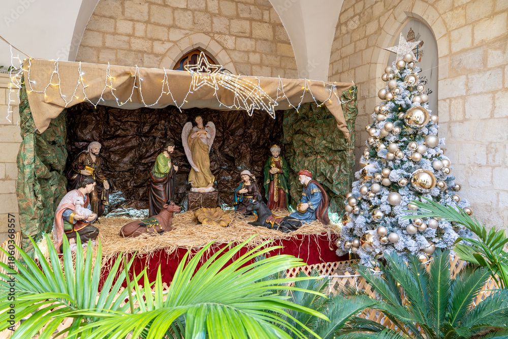 Obraz premium Christmas nativity scene before Christmas Mary and Joseph by the manger in the inner courtyard of the Latin Patriarchate of Jerusalem in the Old City of Jerusalem.Israel