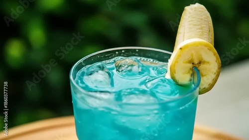 Blue Cocktail with Banana Garnish Outdoor.